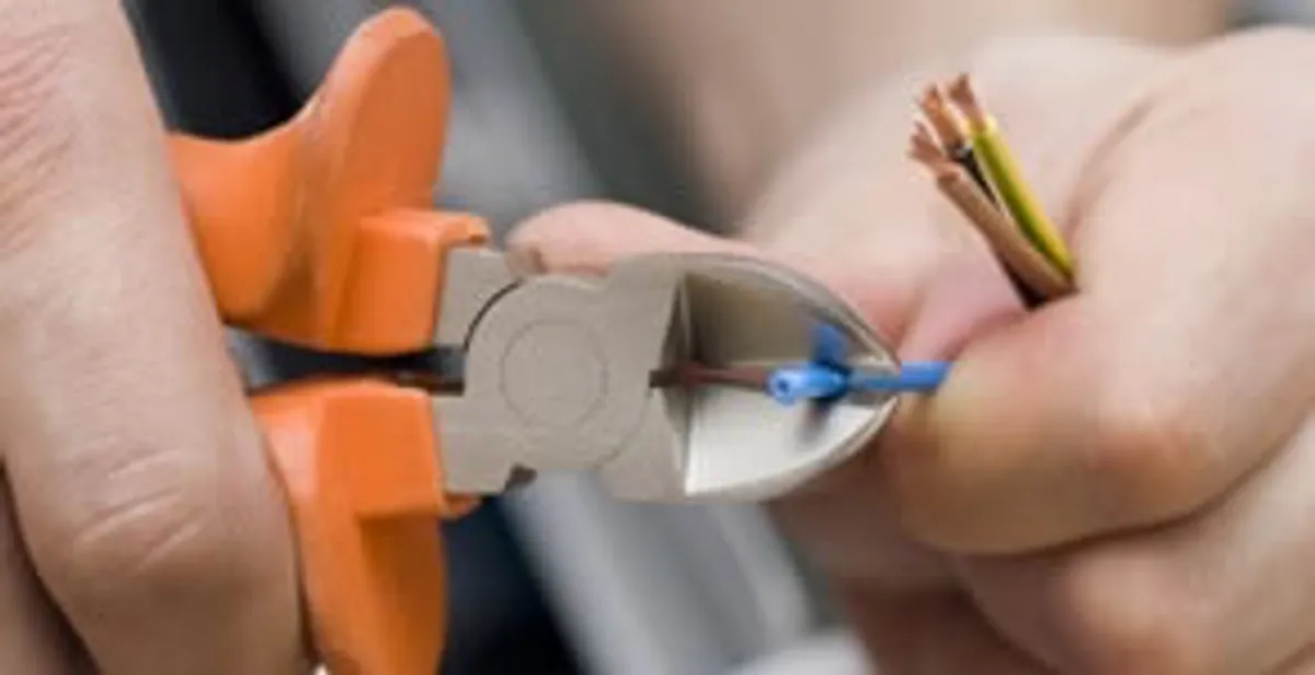 professional electrical services showing precise wire cutting by licensed electricians in Madison, WI